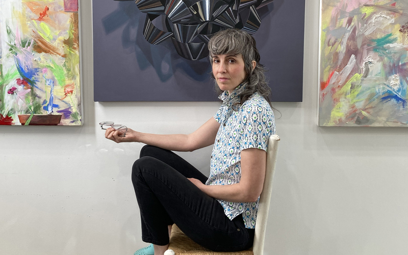 Artist, Melodie Provenzano, in from of her paintings. 
