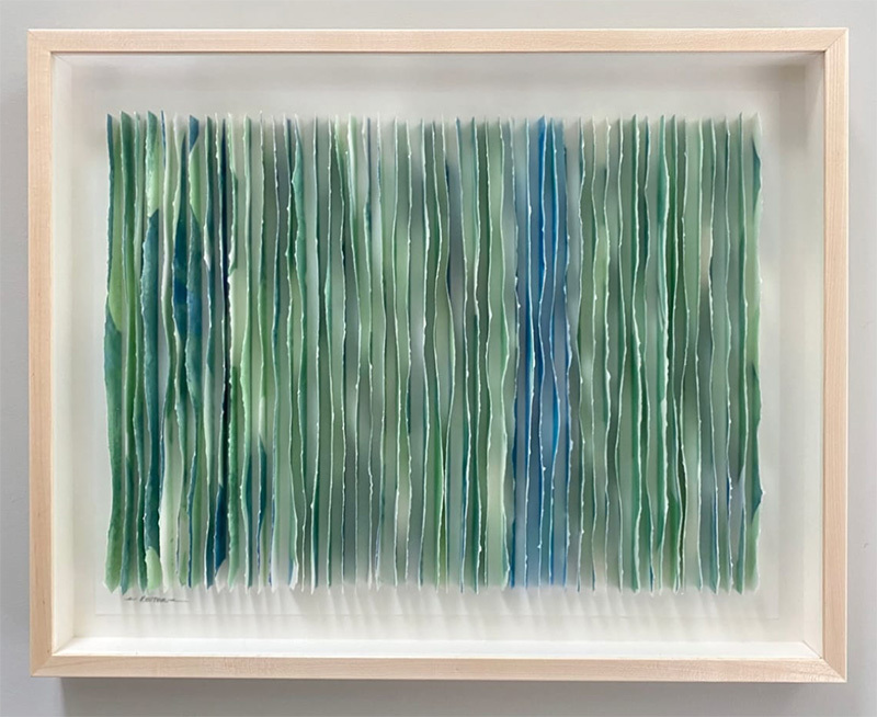 A blue and green framed paper artwork
