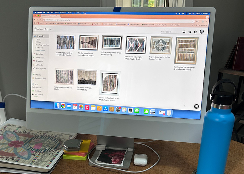 A computer screen with artworks on display