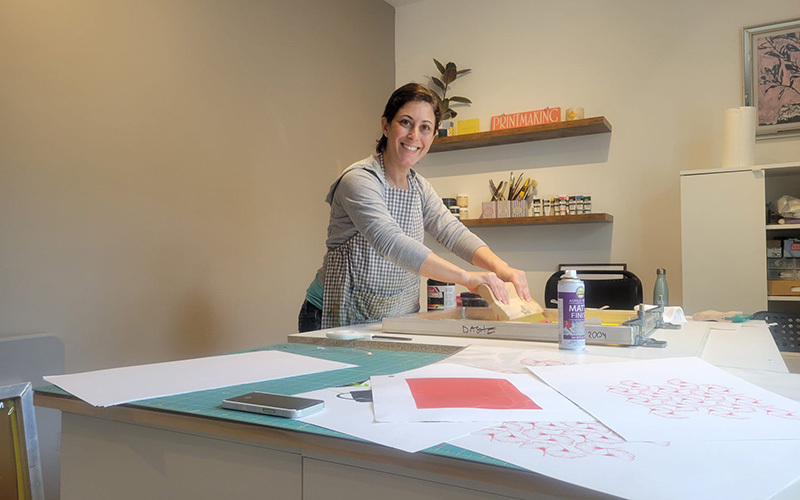 An artist pulling a print