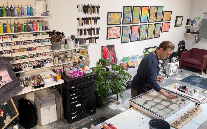 Keith Garubba at work in Whistling Studios, surrounded by the tools, materials, and finished marbled works that fill his Bethlehem, Pennsylvania teaching space. Photo courtesy of the artist.