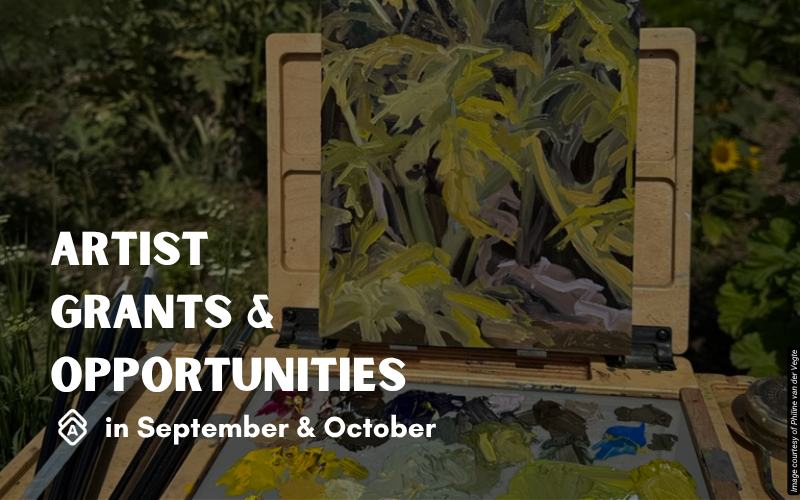 Artist Philine van der Vegte's plein air painting setup shows an easel positioned outdoors in a lush garden setting. The canvas displays an energetic botanical study with bold yellows, greens, purples, and blacks depicting foliage in an expressive, gestural style. The portable wooden easel holds the work steady while a palette with fresh paint in yellows, blues, and other colors sits ready for use. The natural surroundings provide direct inspiration, with dense greenery and plants visible in the background. This outdoor painting practice captures the immediacy of working directly from nature. Text overlay reads "ARTIST GRANTS & OPPORTUNITIES in September" in white letters on the left side of the image.