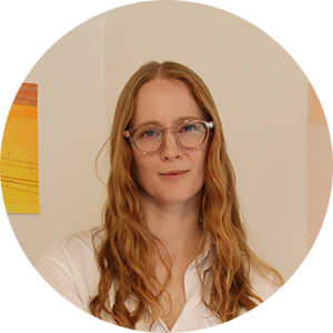 A woman with long hair and glasses