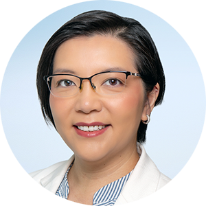 A woman with short hair and glasses