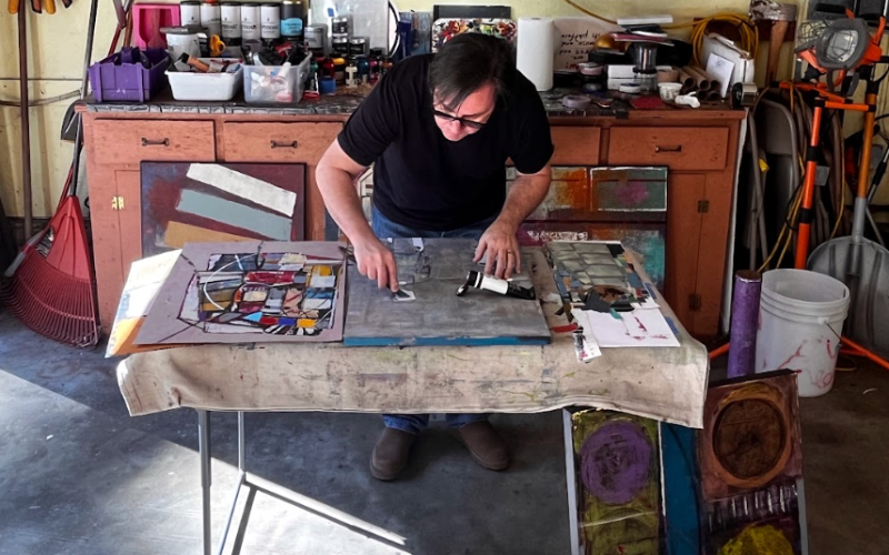 Abstract artist W.S. Cranmore at work on a painting in his studio